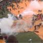 Kenya police fire tear gas to disperse crowds at stadium to view body of ex-PM Odinga
